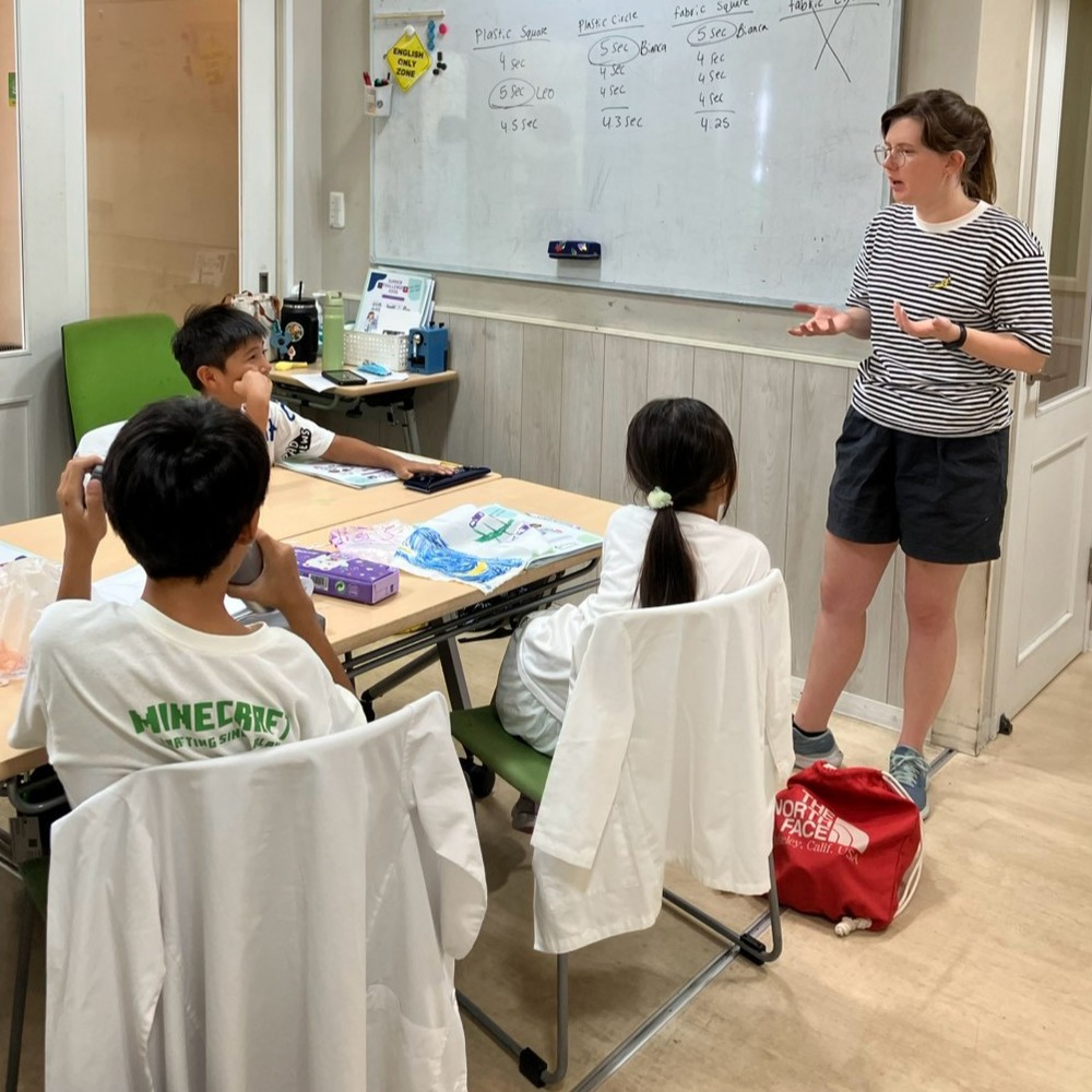 サマースクールで小学生が真剣に先生のお話しを聞いている様子